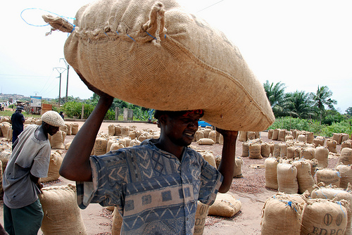 Carrying cocoa bag in Ivory Coast by Flickr user missbax