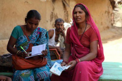 Rural Indian reading  holding KL newspaper. Photo Credit Yashas Chandra
