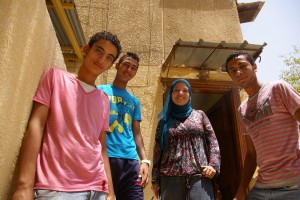 Nesma and three of the youth participants outside Alwan Wa Awtar computer lab